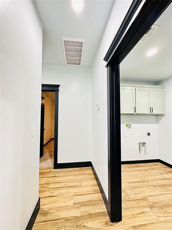 9 SW 24th St, Oklahoma City, OK 73109 - hallway with light wood-style floors and baseboards