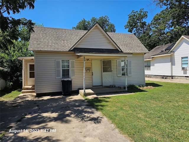 bungalow-style house featuring a front yard