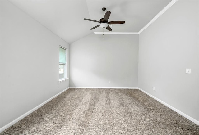 carpeted empty room featuring crown molding, ceiling fan, and lofted ceiling