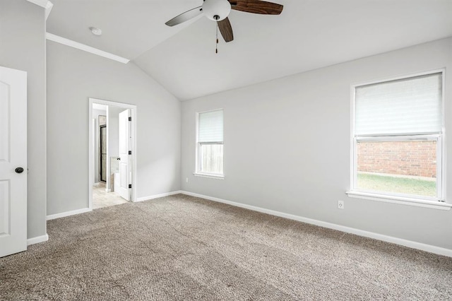 carpeted spare room with ceiling fan and lofted ceiling