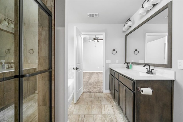 bathroom with ceiling fan, vanity, and shower with separate bathtub