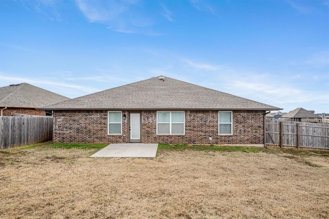 rear view of property with a yard and a patio