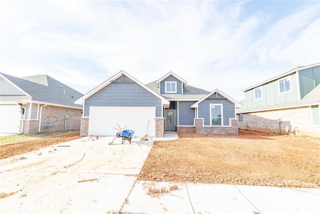 craftsman house with concrete driveway and an attached garage