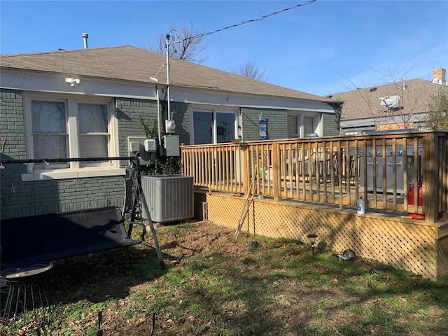 back of house featuring a wooden deck and central AC