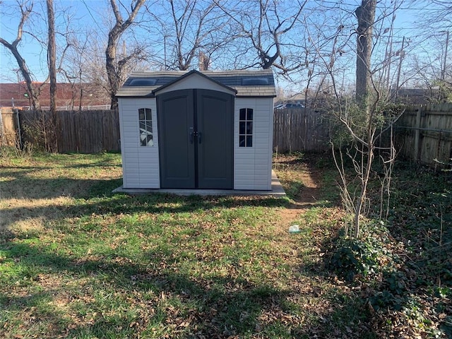 view of outbuilding with a yard