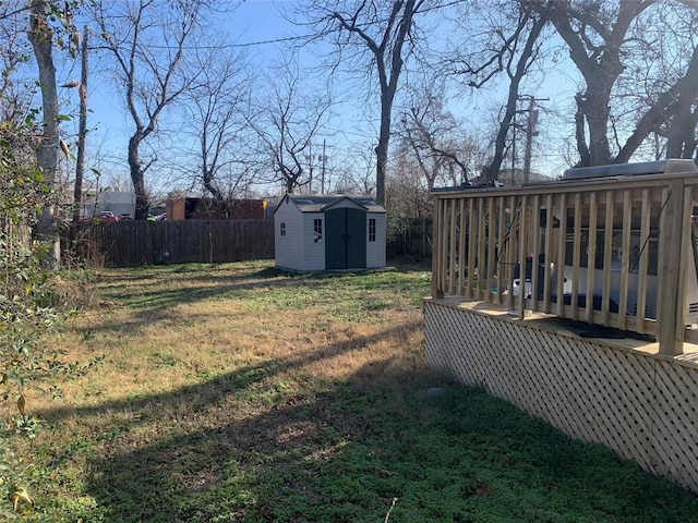 view of yard with a storage shed and a wooden deck