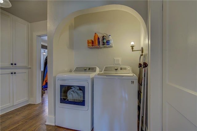 laundry area featuring washer and clothes dryer and dark wood-type flooring