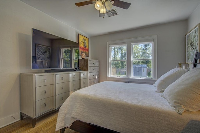 bedroom with ceiling fan and light hardwood / wood-style flooring