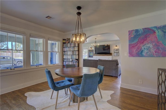 dining space featuring crown molding and wood-type flooring