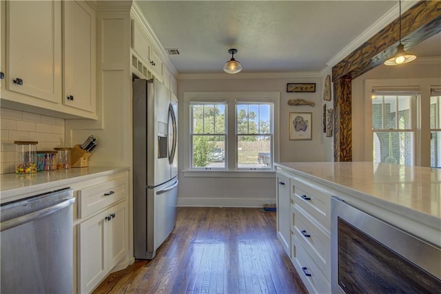 kitchen featuring backsplash, white cabinetry, decorative light fixtures, and appliances with stainless steel finishes