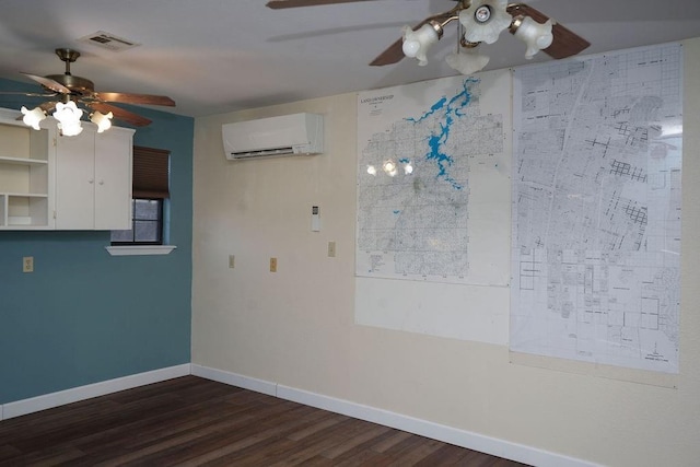 empty room with dark wood-type flooring, an AC wall unit, and ceiling fan