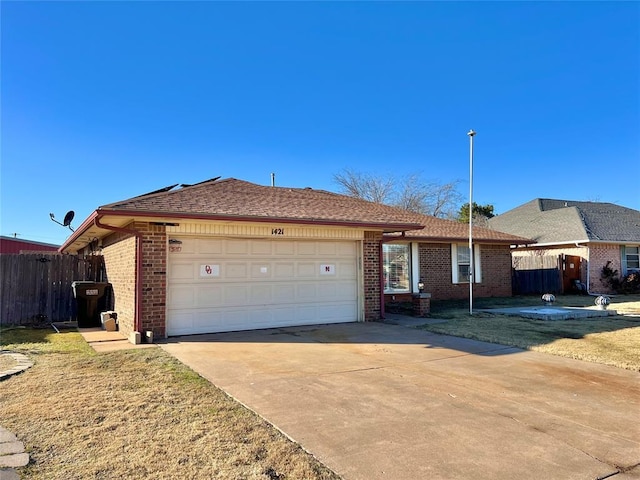 single story home featuring a garage and a front yard