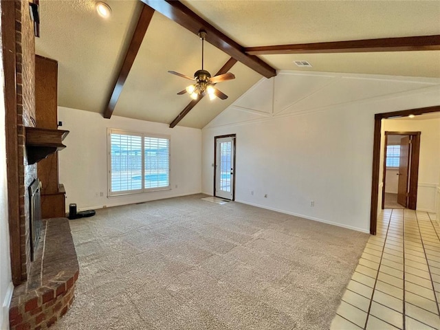 unfurnished living room featuring vaulted ceiling with beams, light colored carpet, ceiling fan, a brick fireplace, and a textured ceiling