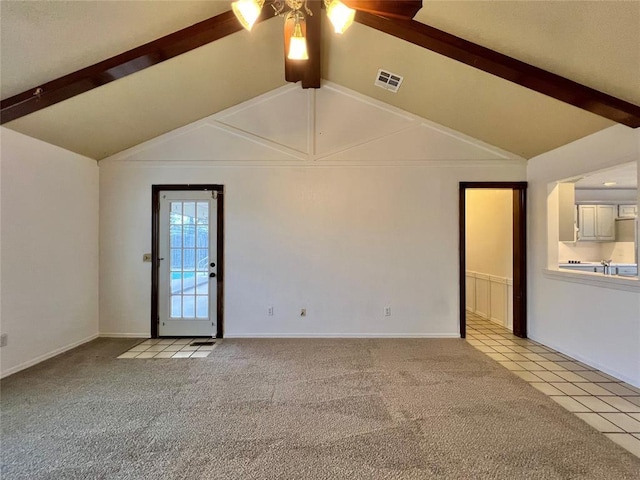 unfurnished room with ceiling fan, lofted ceiling with beams, and light carpet