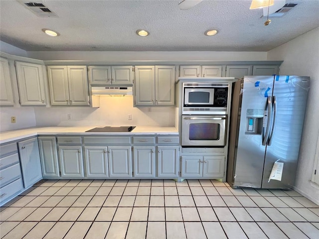 kitchen featuring gray cabinetry, a textured ceiling, and appliances with stainless steel finishes