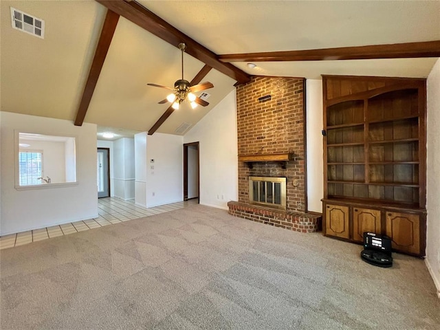 unfurnished living room featuring high vaulted ceiling, beamed ceiling, light colored carpet, ceiling fan, and a brick fireplace