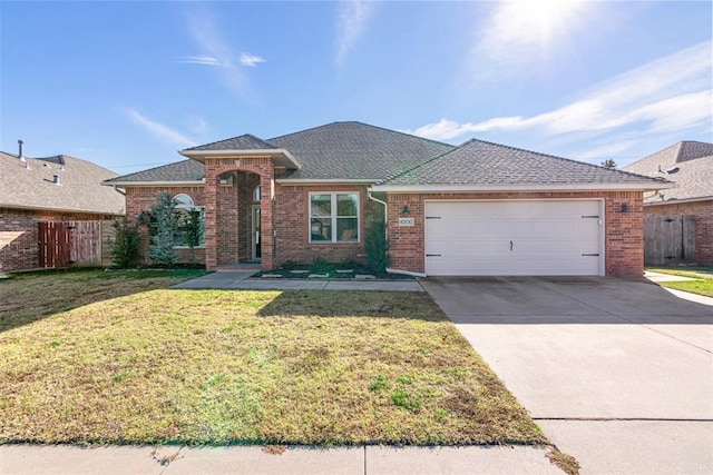 ranch-style house with a front yard and a garage