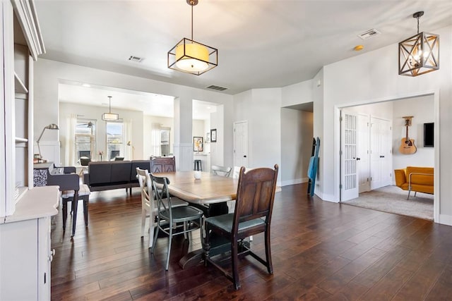 dining space featuring a chandelier and dark wood-type flooring