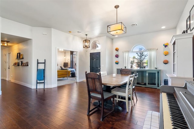 dining area featuring dark hardwood / wood-style floors and a notable chandelier