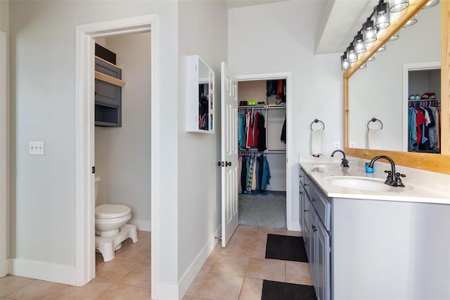 bathroom featuring tile patterned flooring, vanity, and toilet