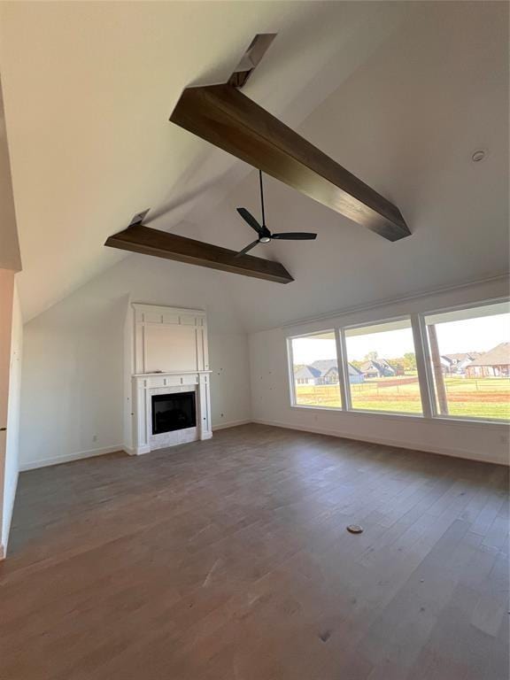 unfurnished living room with ceiling fan, lofted ceiling with beams, and hardwood / wood-style flooring