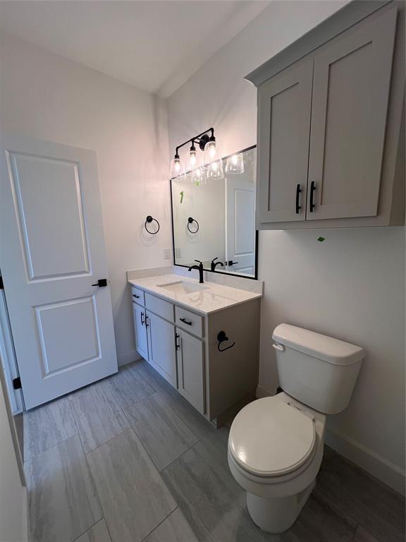 bathroom featuring vanity and toilet