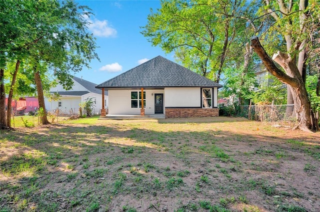 back of property featuring a lawn