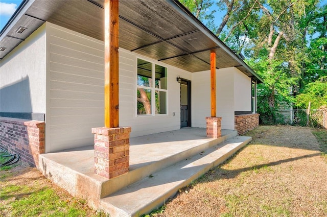 view of side of property featuring covered porch