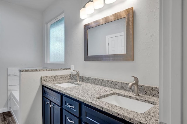 bathroom featuring vanity, a bath, and hardwood / wood-style flooring