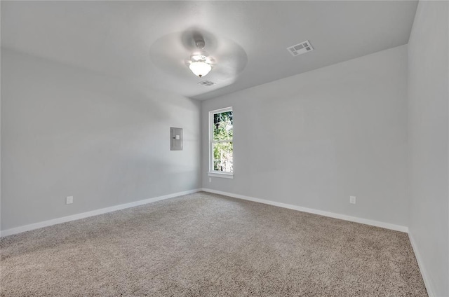 carpeted empty room featuring electric panel and ceiling fan