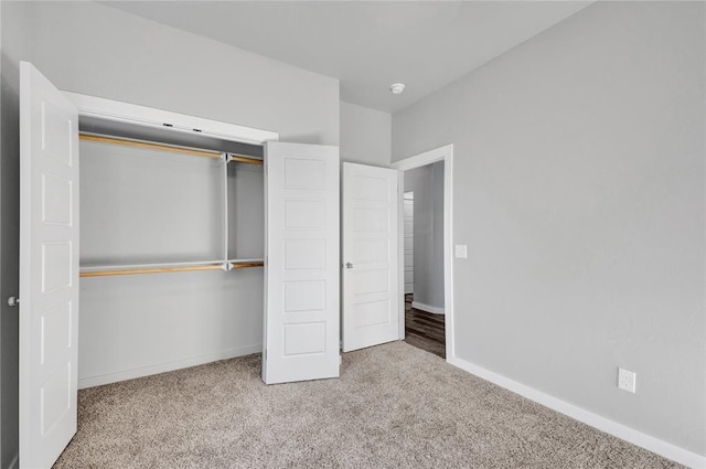 unfurnished bedroom with carpet floors and a closet