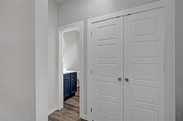 corridor with hardwood / wood-style flooring