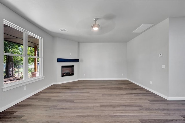 unfurnished living room featuring hardwood / wood-style floors and ceiling fan