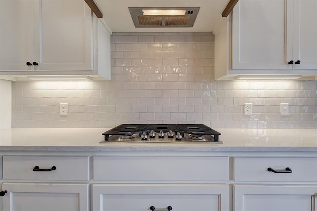 kitchen with backsplash, white cabinetry, and stainless steel gas cooktop