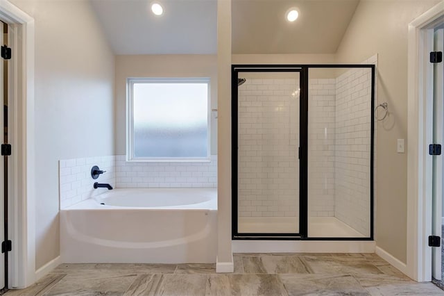 bathroom featuring separate shower and tub and lofted ceiling