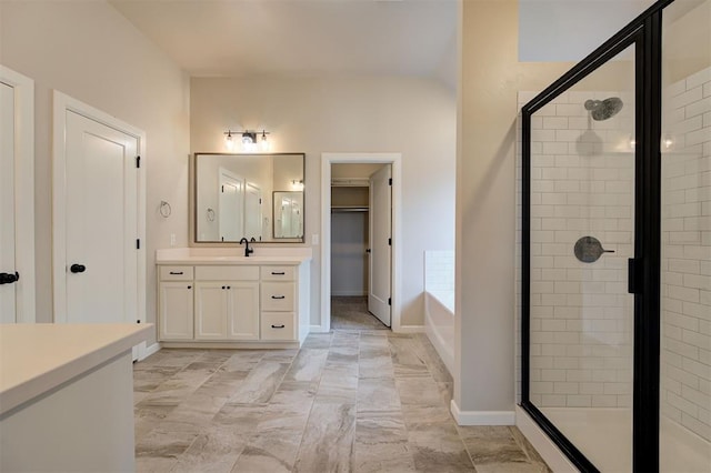 bathroom featuring plus walk in shower and vanity