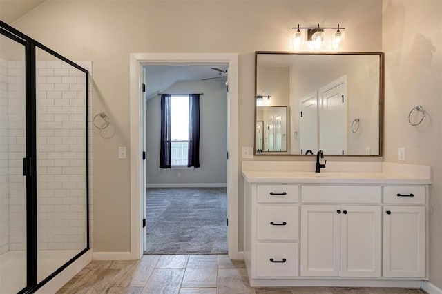 bathroom featuring vanity, a shower with door, ceiling fan, and lofted ceiling