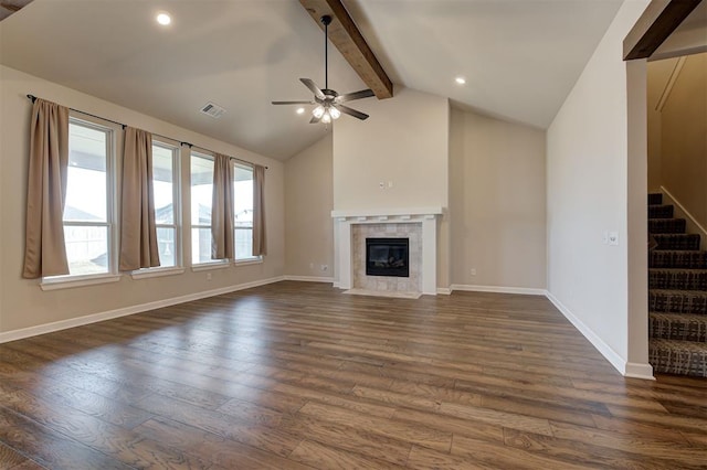 unfurnished living room featuring vaulted ceiling with beams, ceiling fan, dark hardwood / wood-style flooring, and a fireplace