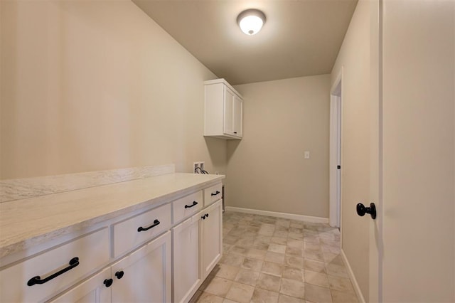 clothes washing area featuring cabinets and washer hookup