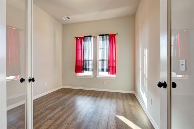 unfurnished room featuring hardwood / wood-style flooring