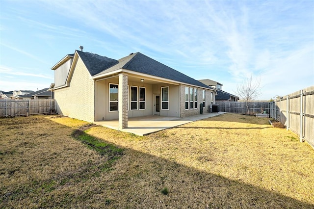 back of house featuring a lawn, a patio area, and central AC unit