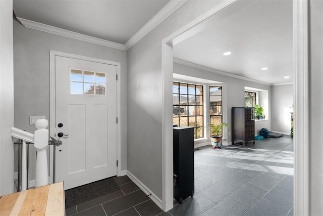 tiled entryway with crown molding and plenty of natural light