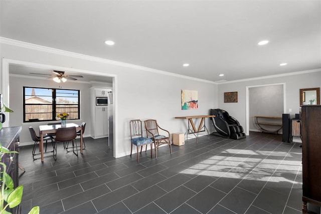 living area with dark tile patterned floors, ceiling fan, and crown molding