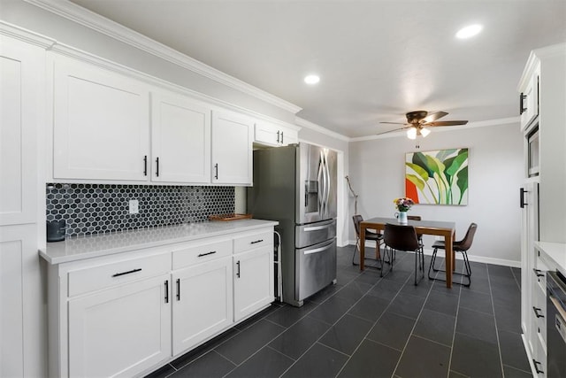 kitchen featuring tasteful backsplash, stainless steel fridge with ice dispenser, and white cabinets