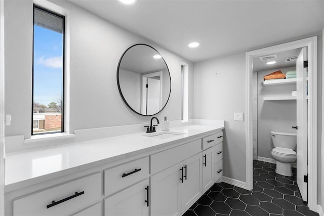 bathroom with vanity and toilet