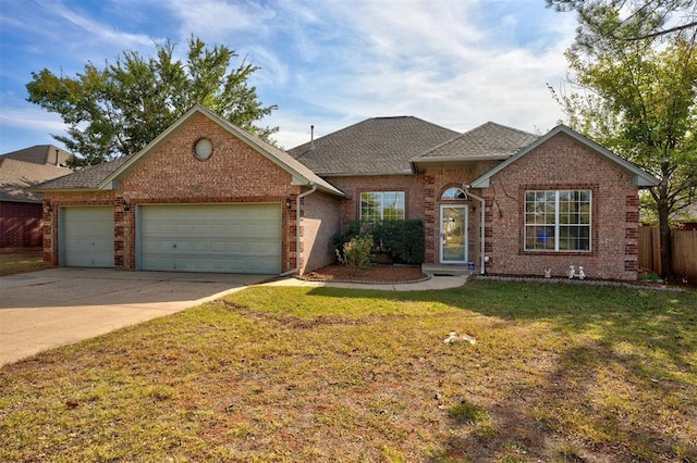 view of front of property featuring a garage and a front lawn