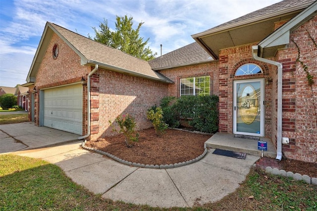 view of exterior entry with a garage