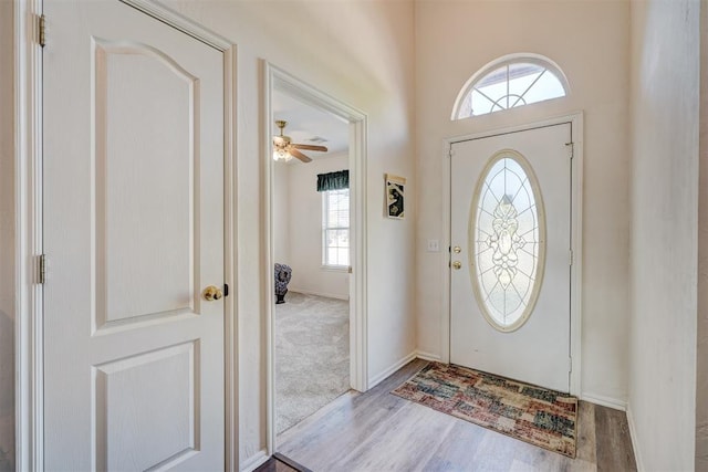 entrance foyer with ceiling fan and light wood-type flooring