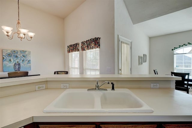 kitchen with an inviting chandelier, hanging light fixtures, and sink