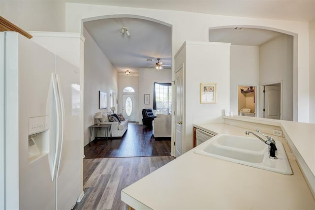 kitchen featuring ceiling fan, sink, hardwood / wood-style floors, and white refrigerator with ice dispenser